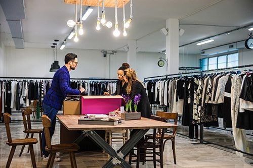 New Business clothing store, team at work on new arrivals